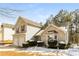 Tan two-story house with double garage and landscaping at 4905 Bridle Point Pkwy, Snellville, GA 30039