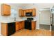 Kitchen with wood cabinets, black appliances, and light countertops at 4905 Bridle Point Pkwy, Snellville, GA 30039