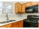 Kitchen features a gas range and stainless steel sink at 4905 Bridle Point Pkwy, Snellville, GA 30039