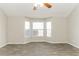 Living room with bay window, ceiling fan, and tile floor at 4905 Bridle Point Pkwy, Snellville, GA 30039