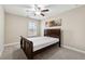 Cozy bedroom with a wooden bed frame and carpeted floor at 4705 Sanderling St, Cumming, GA 30041