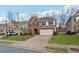 Two-story brick home with a three-car garage and manicured lawn at 4705 Sanderling St, Cumming, GA 30041