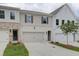 Townhome exterior, two-car garage, neutral color palette, and landscaping at 747 Trevett Way, Marietta, GA 30062