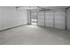 Attached garage with light grey concrete floor and windows at 108 Carrie Mae Ln, Stockbridge, GA 30281