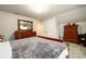 Bedroom with a classic wood bed, dresser, and plush carpet at 3430 Summerpoint Xing, Cumming, GA 30028