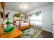 Bedroom features a four-poster bed with decorative fabrics and an adjacent window with decorative drapes at 3430 Summerpoint Xing, Cumming, GA 30028