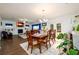 Open concept dining room featuring hardwood floors, chandelier lighting, and seamless flow into living spaces at 3430 Summerpoint Xing, Cumming, GA 30028