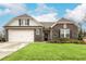Two-story house with stone accents and a landscaped lawn at 3430 Summerpoint Xing, Cumming, GA 30028