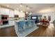 Contemporary kitchen with an island and seating that connects to dining and living areas at 3430 Summerpoint Xing, Cumming, GA 30028