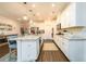 Modern kitchen featuring a spacious island with seating, stainless steel appliances, and ample cabinet space at 3430 Summerpoint Xing, Cumming, GA 30028