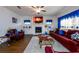 Bright living room showcasing a cozy fireplace, hardwood floors, comfortable seating and bright window views at 3430 Summerpoint Xing, Cumming, GA 30028