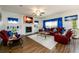 Spacious living room features hardwood floors, fireplace and bright window views with stylish blue valences at 3430 Summerpoint Xing, Cumming, GA 30028