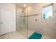 Modern tiled shower features a glass door, window, and sleek hardware at 3430 Summerpoint Xing, Cumming, GA 30028