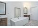 Elegant bathroom with double sinks, soaking tub, and herringbone floors at 18 Peachtree Ne Ave # 1, Atlanta, GA 30305