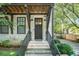 White brick townhome exterior with dark brown front door and steps leading to entrance at 18 Peachtree Ne Ave # 1, Atlanta, GA 30305