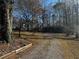 Gravel driveway leading to a cozy cabin-style home at 3430 Holly Springs Pkwy, Canton, GA 30115