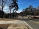 Residential street view, showing a road with trees and a glimpse of houses at 3430 Holly Springs Pkwy, Canton, GA 30115