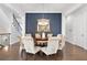 Formal dining room with round table and chandelier, next to staircase at 1 Ganel Ln, Alpharetta, GA 30009