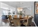 Formal dining room with a round table, chandelier, and dark-blue accent wall at 1 Ganel Ln, Alpharetta, GA 30009