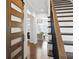 Elegant hallway with hardwood floors, barn door, and modern staircase at 1 Ganel Ln, Alpharetta, GA 30009