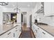 White kitchen with stainless steel appliances and a large island at 1 Ganel Ln, Alpharetta, GA 30009