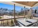 Covered porch with wooded views and outdoor dining furniture at 1 Ganel Ln, Alpharetta, GA 30009