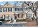 Two story townhome with brick and siding exterior, front porch, and landscaping at 273 Devonshire Dr, Alpharetta, GA 30022