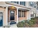 Townhome entrance with brick facade, black door, and porch at 273 Devonshire Dr, Alpharetta, GA 30022