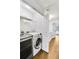 Laundry room with washer, dryer, and shelving at 273 Devonshire Dr, Alpharetta, GA 30022