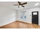 Bright living room with hardwood floors, ceiling fan, and large window at 273 Devonshire Dr, Alpharetta, GA 30022