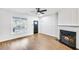 Living room featuring hardwood floors, fireplace, and ceiling fan at 273 Devonshire Dr, Alpharetta, GA 30022