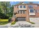 Brick front exterior of charming townhome with attached garage and manicured lawn at 3155 Boldmere Se Trl # 3, Smyrna, GA 30080