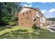 Side view of townhome showcasing brick exterior, deck, and grassy yard at 3155 Boldmere Se Trl # 3, Smyrna, GA 30080