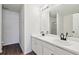 Double vanity bathroom with white cabinets and black faucets at 520 Dragonfly Ct, Cumming, GA 30040