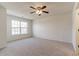 Bright bedroom with large window, ceiling fan, and carpeting at 520 Dragonfly Ct, Cumming, GA 30040