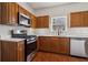 Modern kitchen with stainless steel appliances and wood cabinets at 520 Dragonfly Ct, Cumming, GA 30040