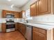 Modern kitchen with stainless steel appliances and wood cabinets at 520 Dragonfly Ct, Cumming, GA 30040