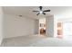 Large living room with carpeted floor and view into kitchen at 520 Dragonfly Ct, Cumming, GA 30040