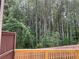 View of the wooded backyard from the wood deck and fence at 1356 Lucan Ln # Wc226, Lawrenceville, GA 30043