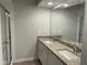Bright bathroom with double sinks, granite countertops, and a glass-enclosed shower at 1356 Lucan Ln # Wc226, Lawrenceville, GA 30043