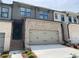 Charming two-story townhome featuring a two-car garage and stylish brick and siding exterior at 1356 Lucan Ln # Wc226, Lawrenceville, GA 30043