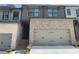 Charming two-story townhome featuring a two-car garage and stylish brick and siding exterior at 1356 Lucan Ln # Wc226, Lawrenceville, GA 30043