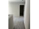 Hallway featuring unfinished flooring, and a doorway leading to another room at 1356 Lucan Ln # Wc226, Lawrenceville, GA 30043