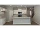 Modern kitchen with white cabinets, stainless steel appliances, and a center island at 1356 Lucan Ln # Wc226, Lawrenceville, GA 30043