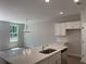 Bright kitchen featuring white cabinets, quartz countertops, and stainless steel appliances at 1356 Lucan Ln # Wc226, Lawrenceville, GA 30043