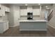 Bright kitchen with white cabinets, stainless steel appliances, and a large island at 1356 Lucan Ln # Wc226, Lawrenceville, GA 30043
