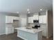 Modern kitchen with white cabinets, stainless steel appliances, and a center island with a sink at 1356 Lucan Ln # Wc226, Lawrenceville, GA 30043