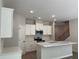 Modern kitchen with white cabinets, stainless steel appliances, and a center island at 1356 Lucan Ln # Wc226, Lawrenceville, GA 30043