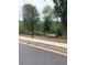 Residential street with sidewalk, benches, and trees at 1356 Lucan Ln # Wc226, Lawrenceville, GA 30043