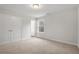 Neutral-toned bedroom featuring carpet, white trim, a window and double door closet at 344 Riverwood Pass, Dallas, GA 30157